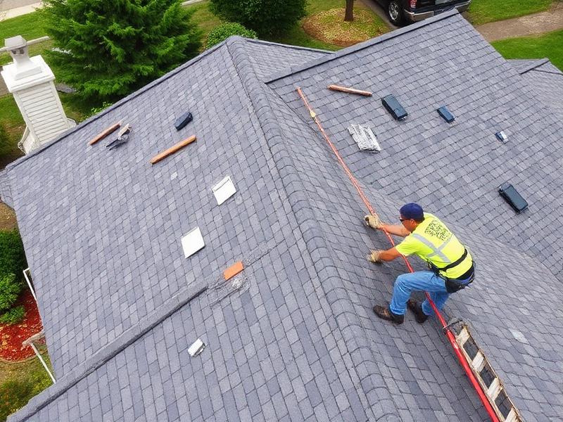 Roof repair worker fixing storm damage